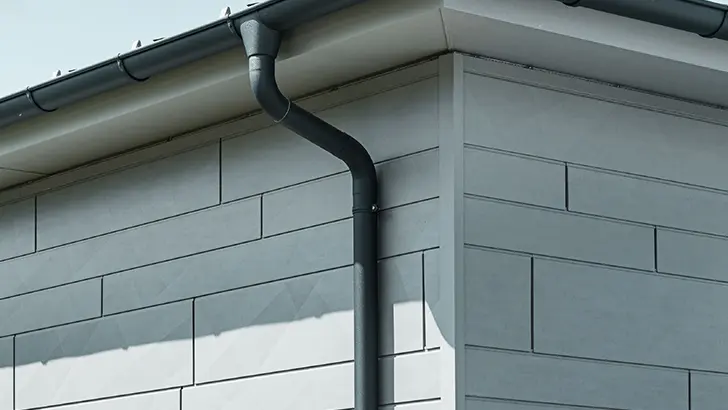 PREFA Dachrinne mit Ablaufrohr in Anthrazit dazu eine PREFA Siding.X Fassade